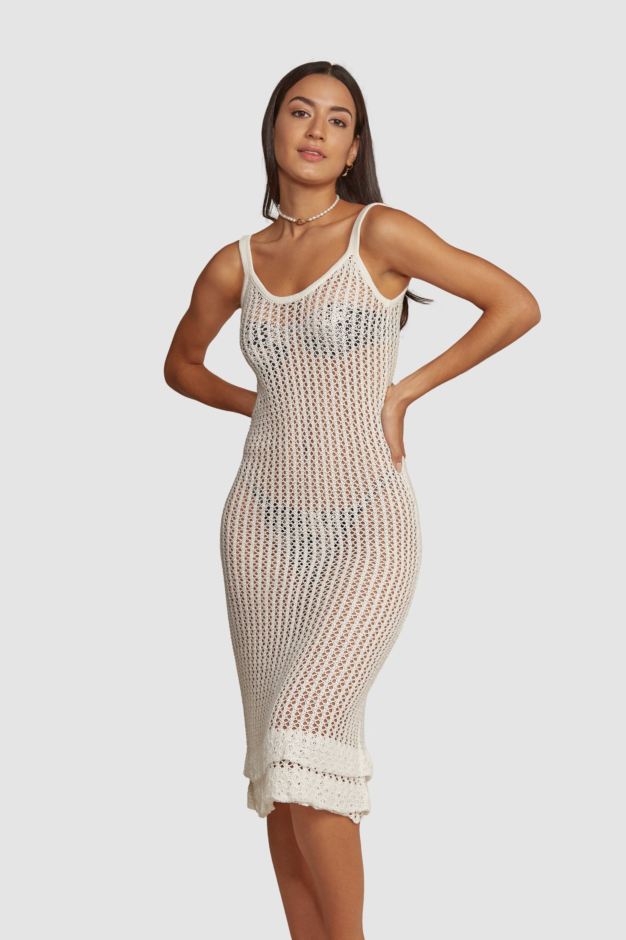Aldana is a cami style dress designed to subtly hug the body, flattering all figures. A go-to cover-up that is easily dressed up or down. Features a double hem detail. Handmade crochet by Peruvian artisans. 100% cotton. Made in Peru.