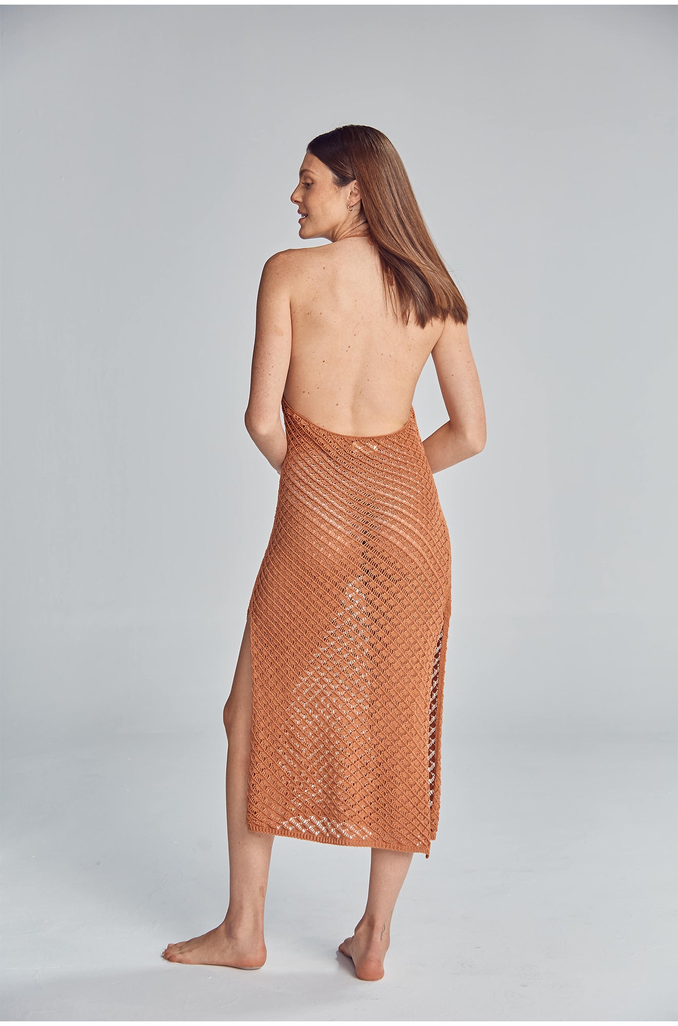 Halter midi dress featuring a side slit, and fully exposed back. Handmade crochet by Peruvian artisans.  50% Cotton 50% Polyester. Made in Peru.