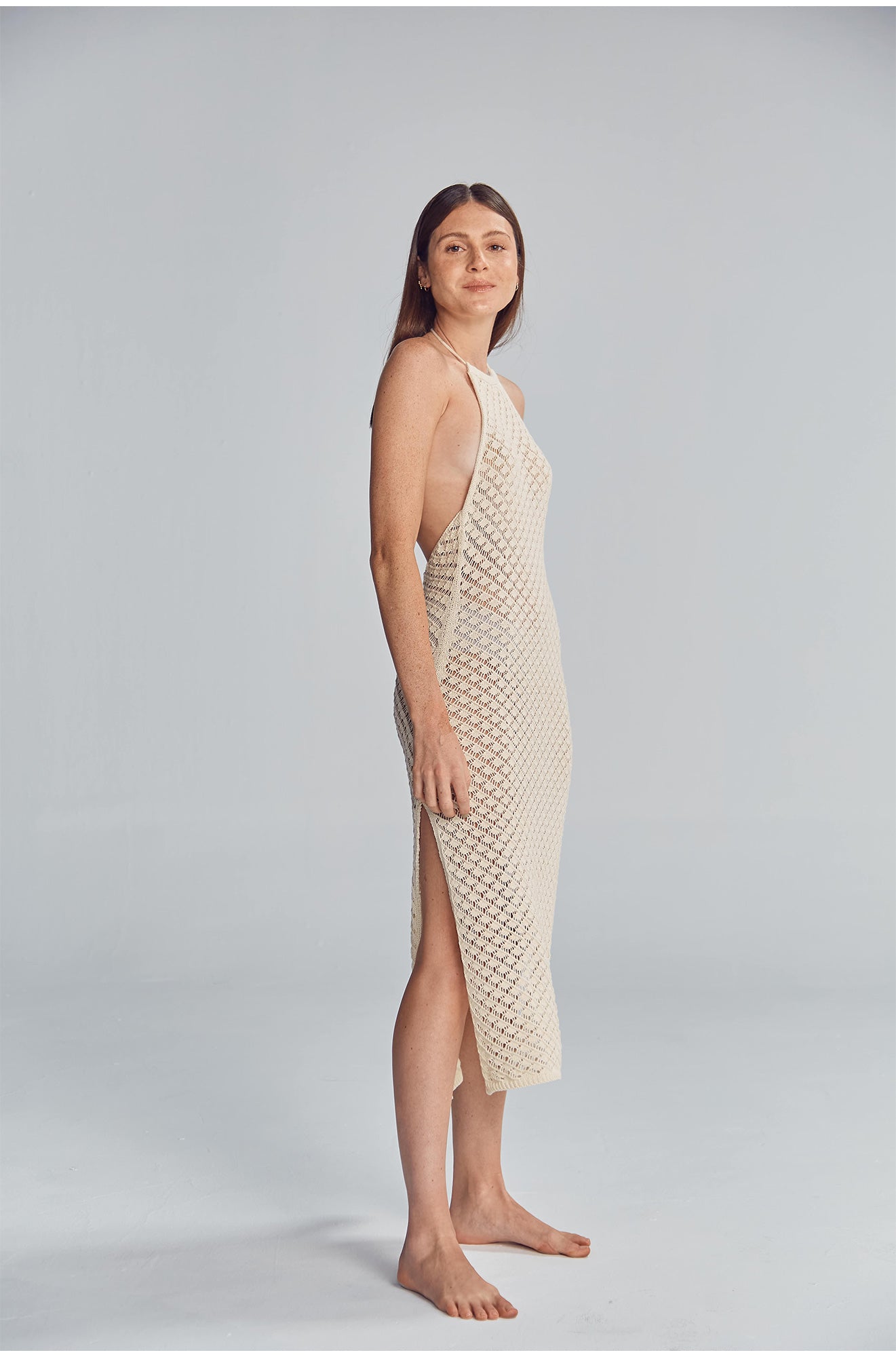 Halter midi dress featuring a side slit, and fully exposed back. Handmade crochet by Peruvian artisans.  50% Cotton, 50% Polyester. Made in Peru