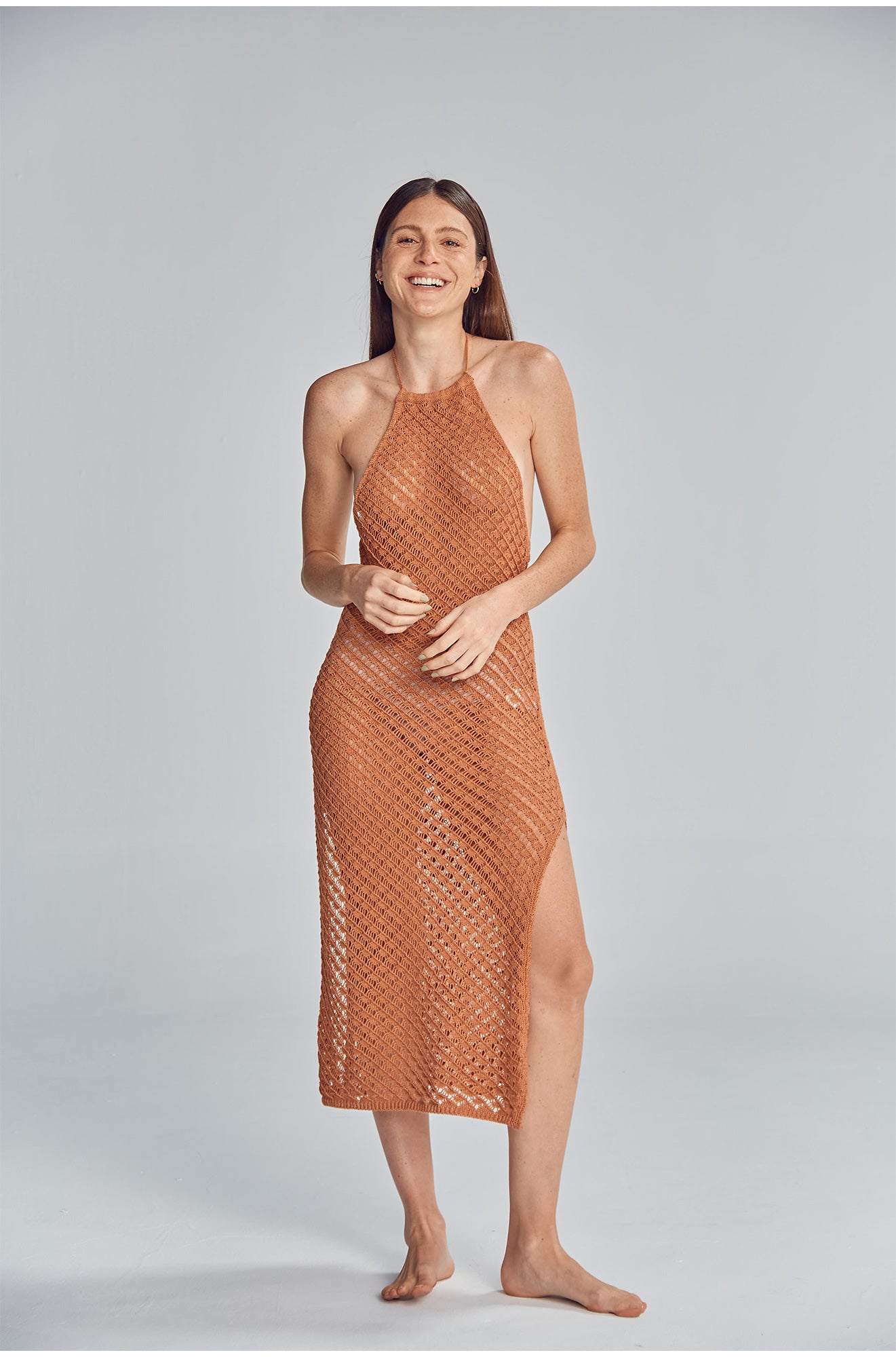 Halter midi dress featuring a side slit, and fully exposed back. Handmade crochet by Peruvian artisans.  50% Cotton 50% Polyester. Made in Peru.
